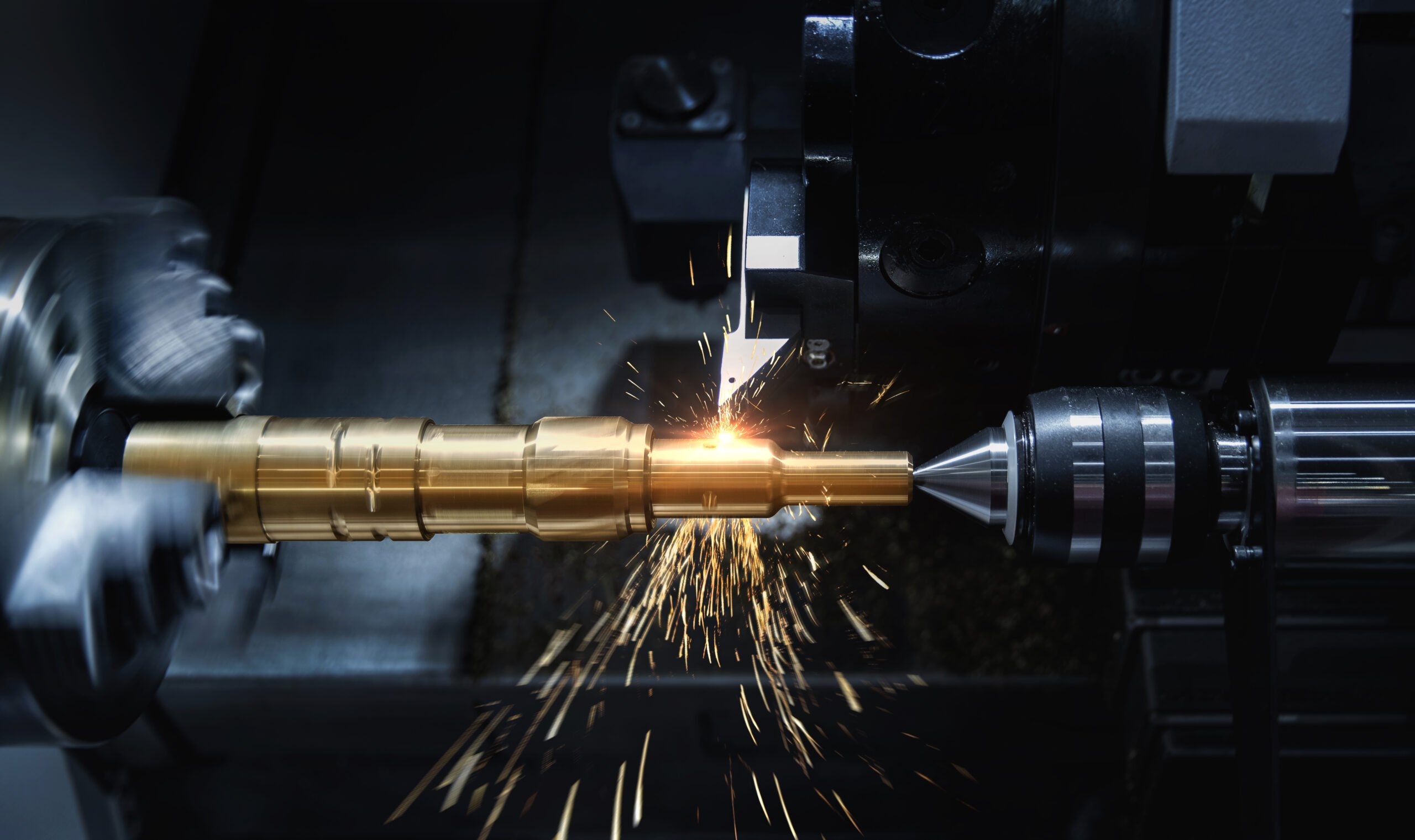 A milling head with a drill bit. Machine outputs are showing in the background.
